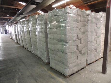 many pallets of attic blow-in cellulose insulation in the warehouse